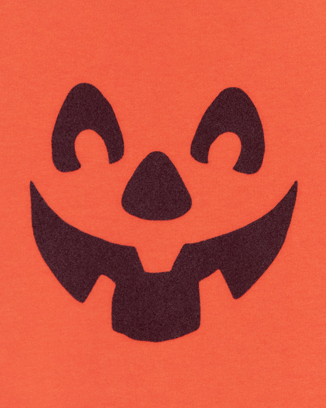 Pumpkin Tee features a black jack-o’-lantern face with a big grin on an orange background—ideal for vintage style or your fun Halloween Tees collection.