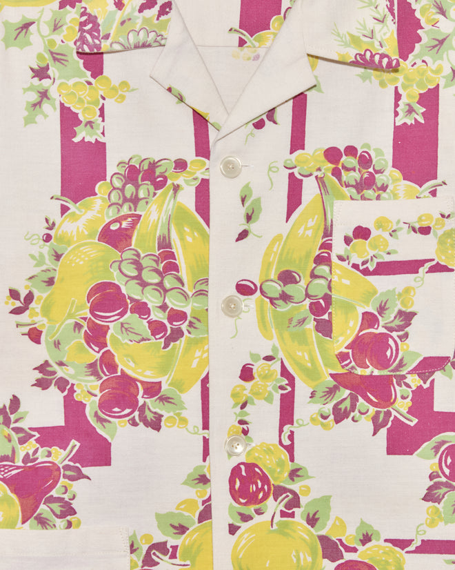 Close-up of the Banana Bunch Short Sleeve Shirt (L/XL), a unique shirt with a colorful fruit pattern in yellow, purple, and green, featuring buttons and a collar.