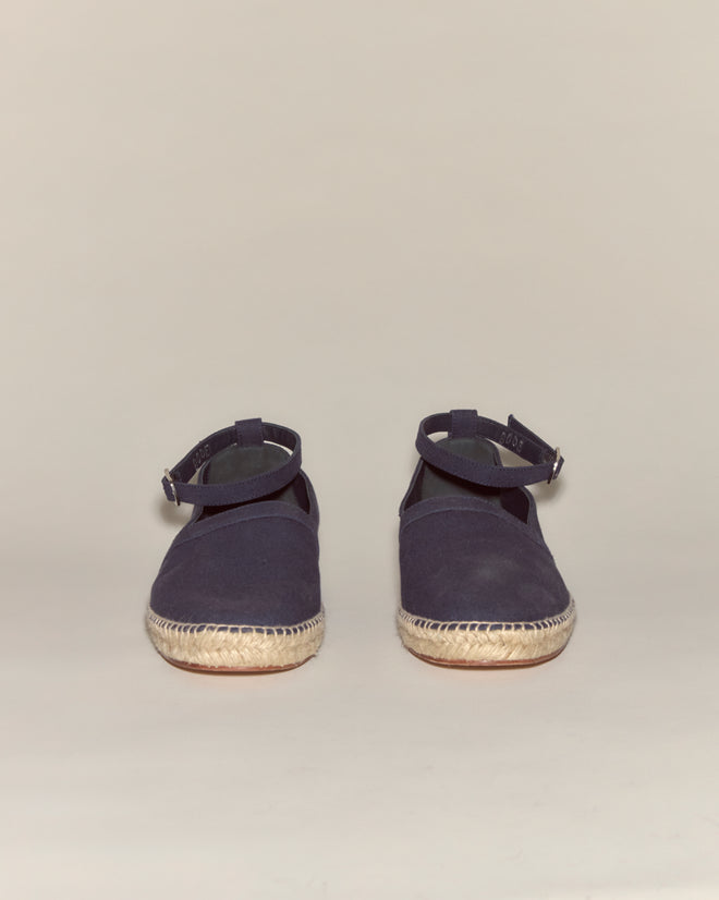 A pair of Canvas Slip-On Espadrilles - Navy featuring a classic jute sole, displayed on a plain beige background.