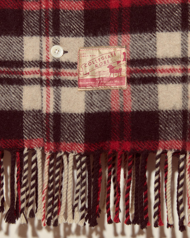 The Collegiate Buffalo Overshirt - XXL features a plaid wool design in red, black, and cream, with a white button and fringed ends, inspired by vintage Brownsville Woolen Mills craftsmanship and made in New York.