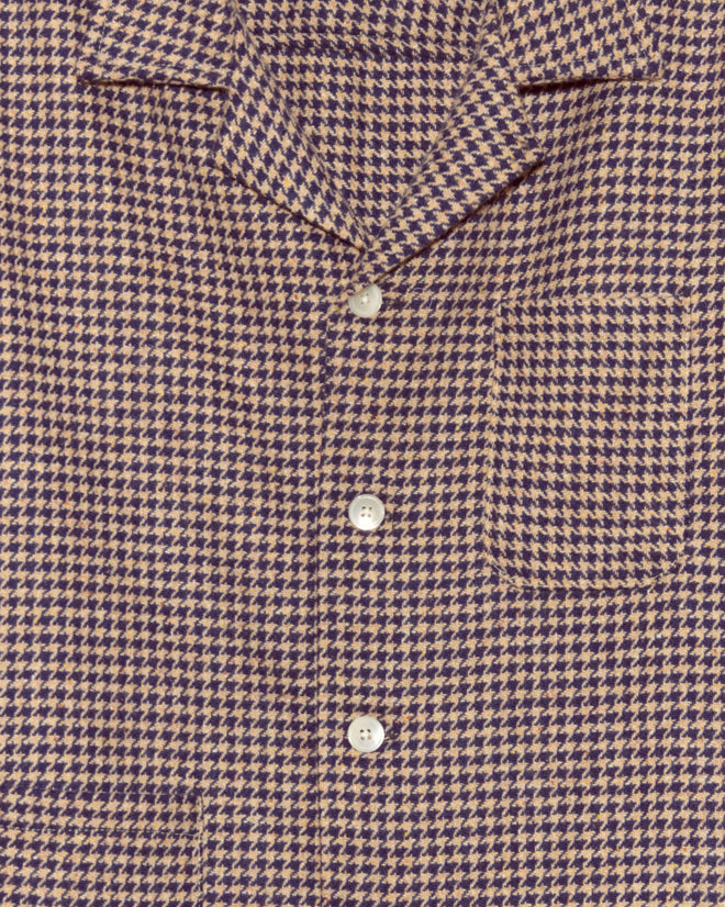 Close-up of the Confetti Houndstooth Overshirt - S/M, crafted in New York from deadstock wool with a brown and dark blue houndstooth pattern, white buttons, and a chest pocket.