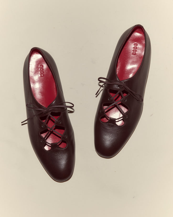 County Clare Shoes - Brown: Women's Italian-made lace-up flats in dark brown Napa leather with red insoles on a light background.