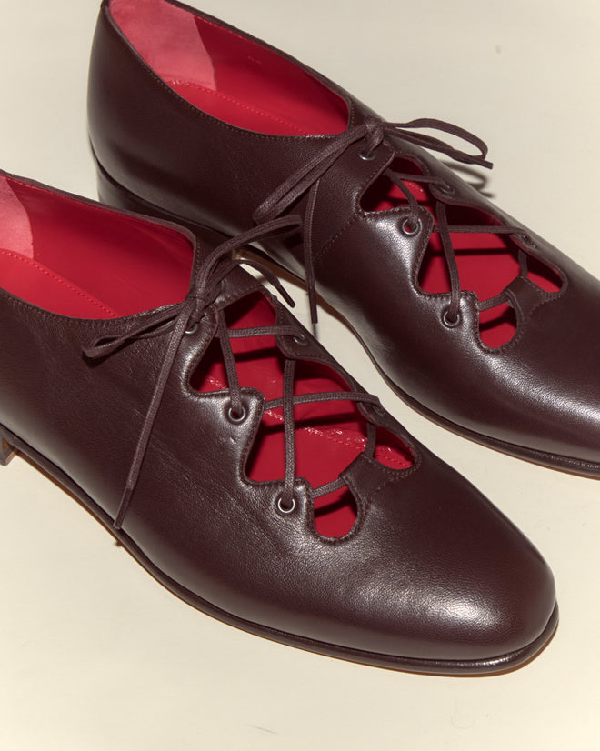 County Clare Shoes - Brown: Italian leather lace-up shoes in dark brown, featuring a striking bright red inner lining, displayed on a light surface.