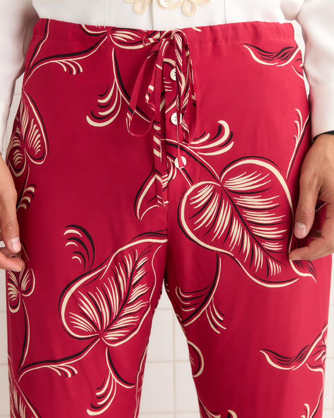 Person wearing Creeping Begonia Pajama Pants, featuring a bold white and black botanical print, with hands resting at their sides.