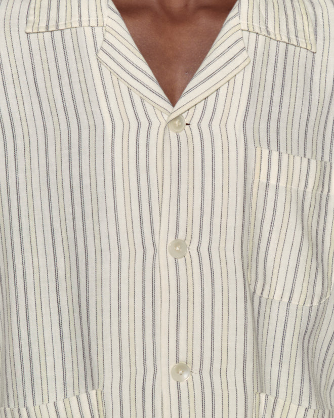 Close-up of the Electric Light Long Sleeve: a cream flannel shirt with thin vertical stripes, notched collar, buttons, and chest pocket. Crafted from 100% cotton for comfort and style.