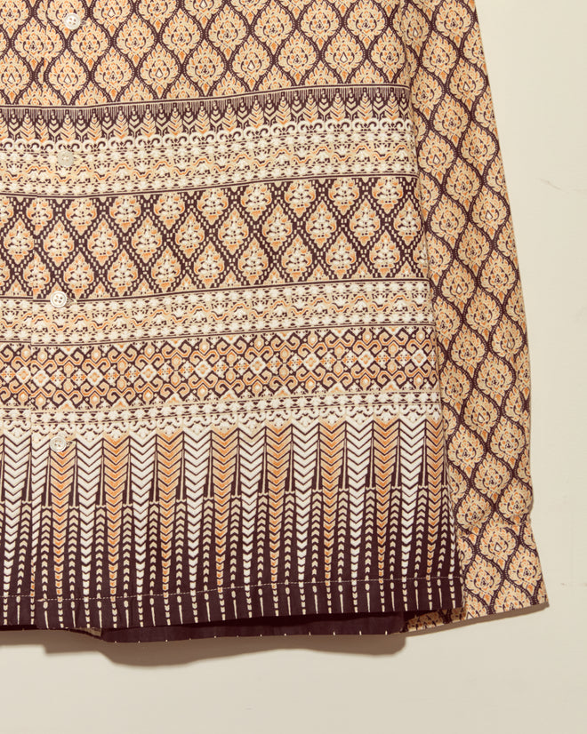 The Fictile Flame Long Sleeve Shirt - L/XL features bold brown and cream wax-printed geometric and floral patterns, ideal for a unique, standout African shirt, displayed elegantly against a light background.
