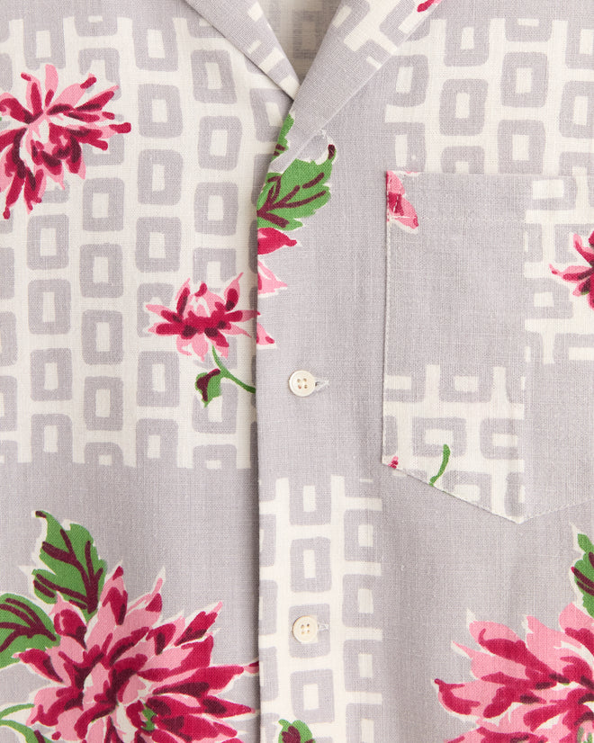 Close-up of the Floral Kale Shirt (XS/S), featuring light gray fabric with pink floral prints, geometric patterns, buttons, and a chest pocket—a unique piece inspired by 1950s-1960s fashion.