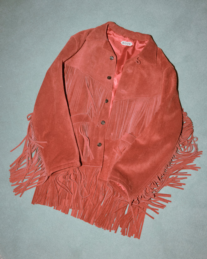 The Appalachian Jacket - Red features hand-cut suede fringe and buttons, shown laid flat on a light green background—a stylish nod to Western costume design.