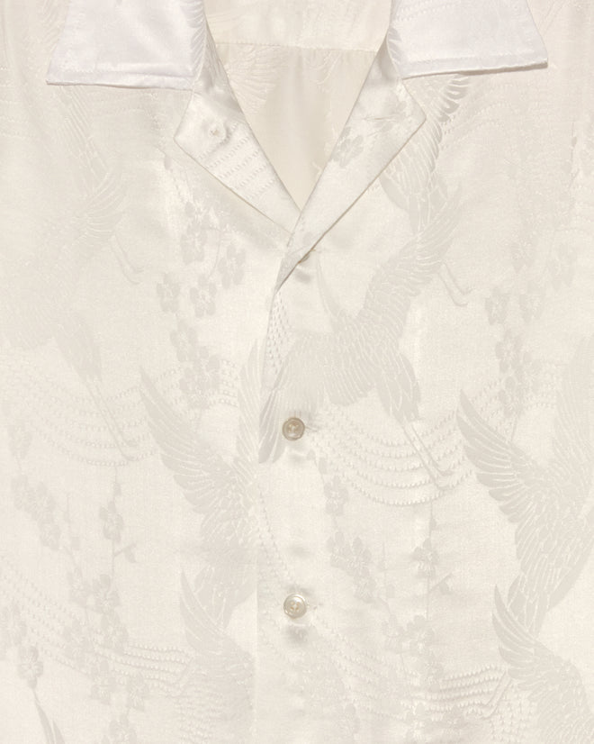 Close-up of the Ivory Cloud Long Sleeve Shirt, crafted in New York with a subtle crane and cherry blossom motif on white jacquard and finished with pearl buttons.