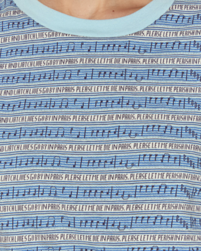Close-up of the Lyric Cropped Tee in blue, featuring musical notes and repeated text: