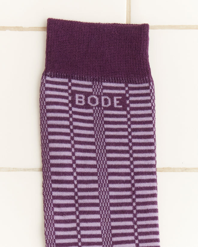 The Micro Check Socks - Purple feature a playful purple and lavender striped design with bold BODE text, reminiscent of vintage children's socks, displayed on a white tiled background.