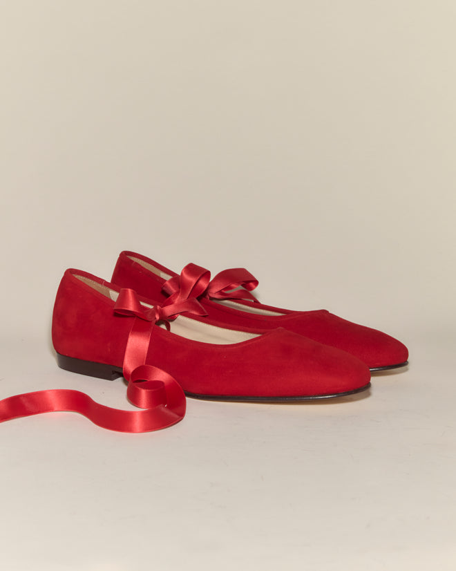 Two Musette Flats - Chili, featuring vintage style and satin ribbon ties, are displayed on a light beige background.