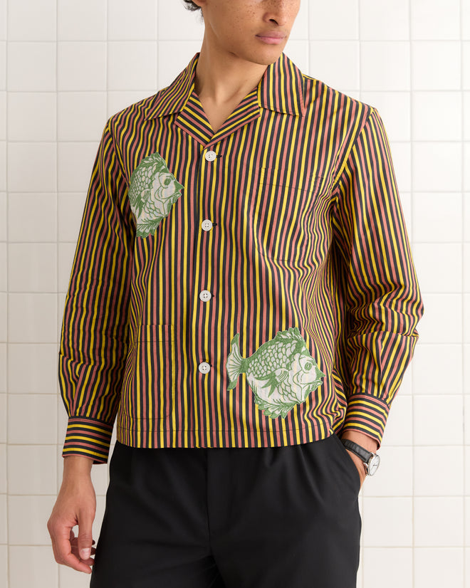 Person wearing the Fish Appliqué Long Sleeve Shirt, inspired by 1950s-1960s fashion, stands against a tiled white wall.