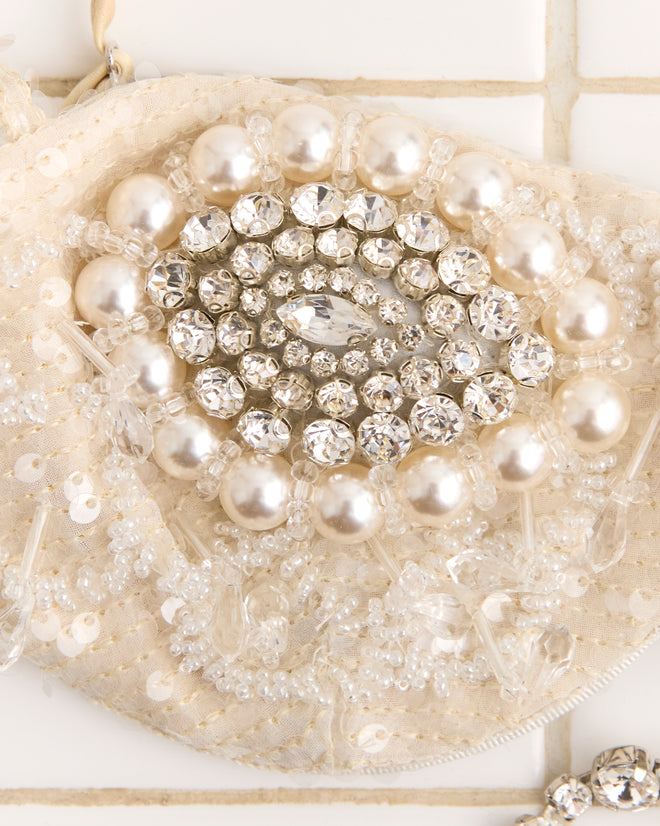 Close-up of the Oyster Bra - Silver, featuring intricate beadwork and pearl embellishments, displayed on a tiled white background.