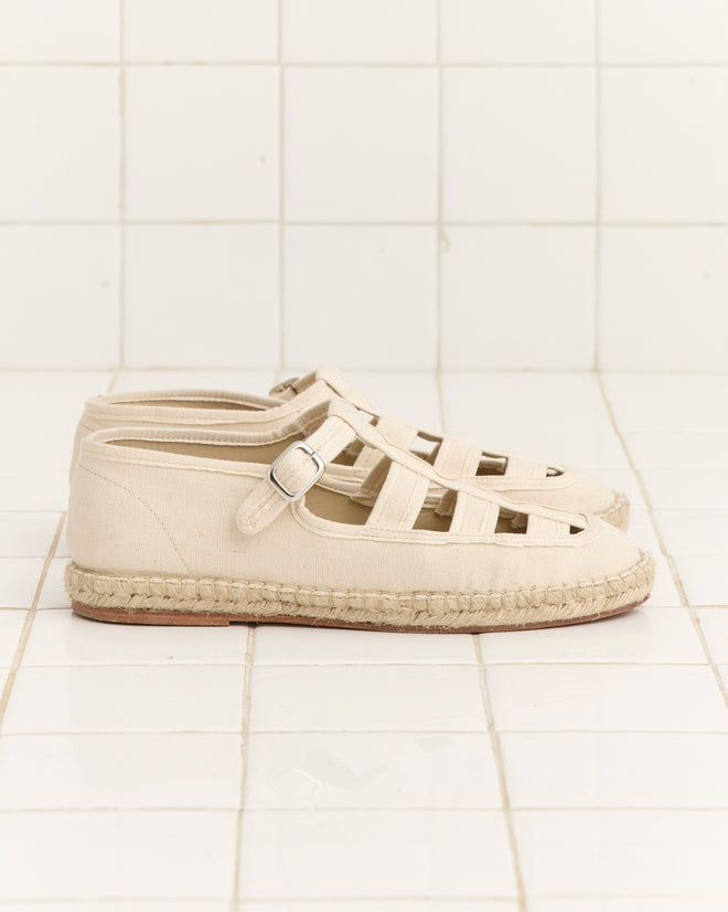 Peggy Espadrilles - Natural: beige jute espadrille sandals with buckle straps, displayed side by side on white tiles—ideal summer shoes for easy, stylish looks.