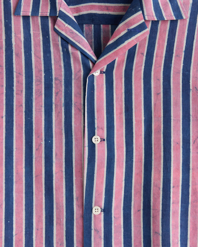 Close-up of the Pink Paint Stripe Shirt, featuring vertical blue and pink stripes and white buttons, made from deadstock yardage for unique style.