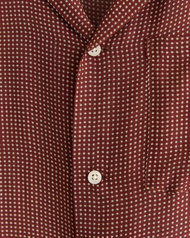 Close-up of the maroon Polo Dot Shirt, made in New York, featuring a white dot pattern, white buttons, and a visible chest pocket.