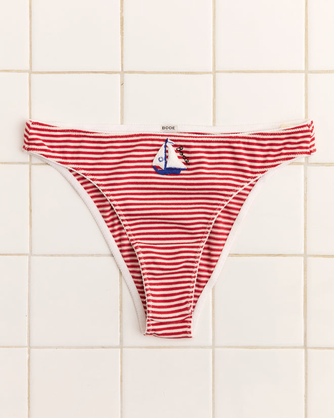 Sailboat Briefs: red and white striped high-cut briefs featuring an appliquéd sailboat patch, shown on a tiled background.
