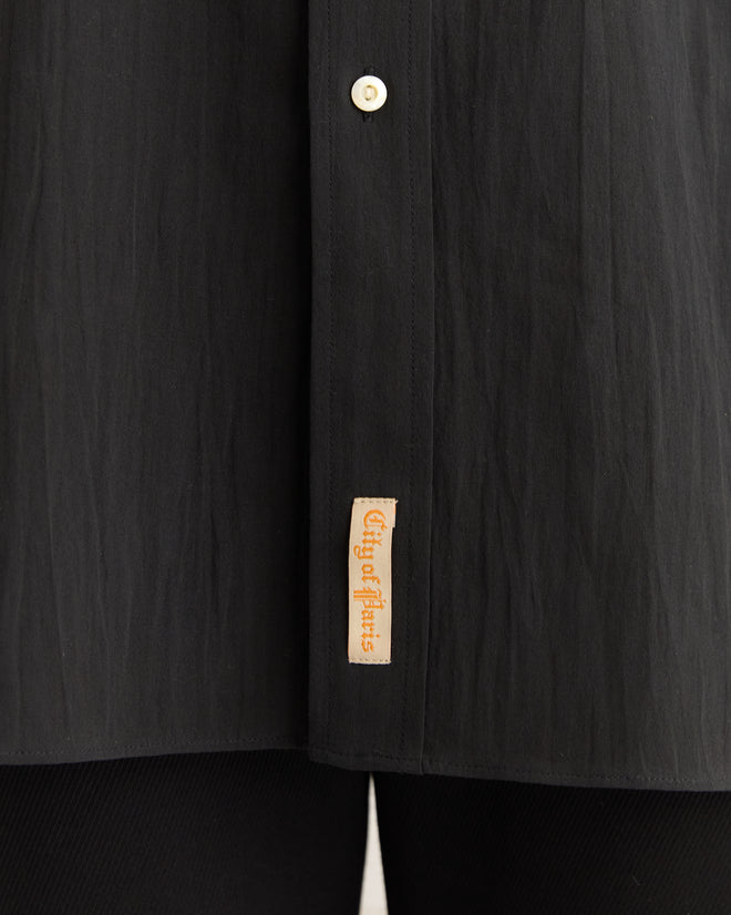 Close-up of the Voile Murray Shirt - Black, featuring a beige