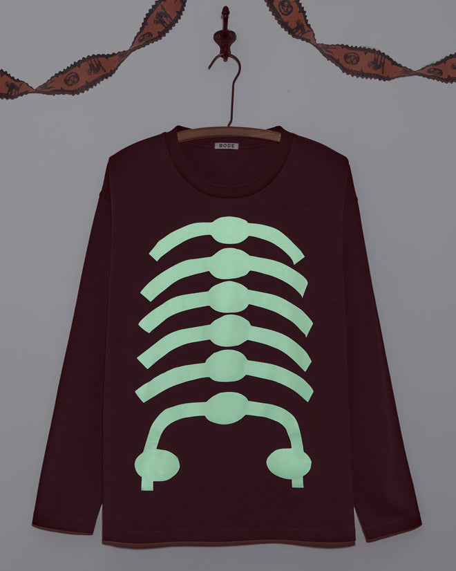 The Skeleton Long Sleeve Tee features a bold glow-in-the-dark skeleton design, adding spooky style to your outfit both day and night.