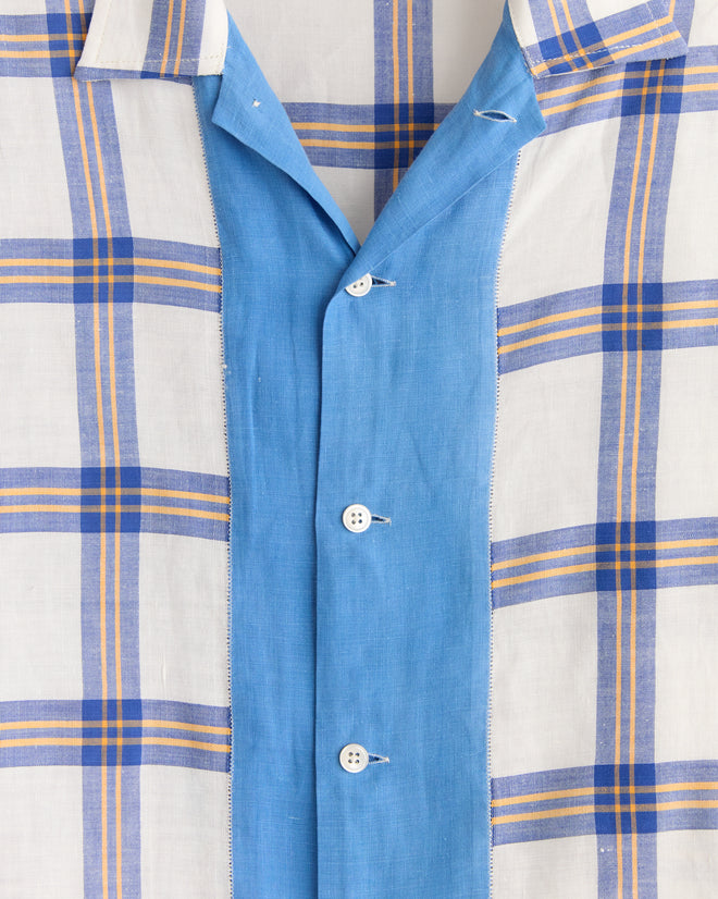 Close-up of the Skylight Window Long Sleeve Shirt - XS/S, crafted from vintage bedsheets with a blue, white, and yellow plaid pattern and finished with a blue button placket featuring white buttons.