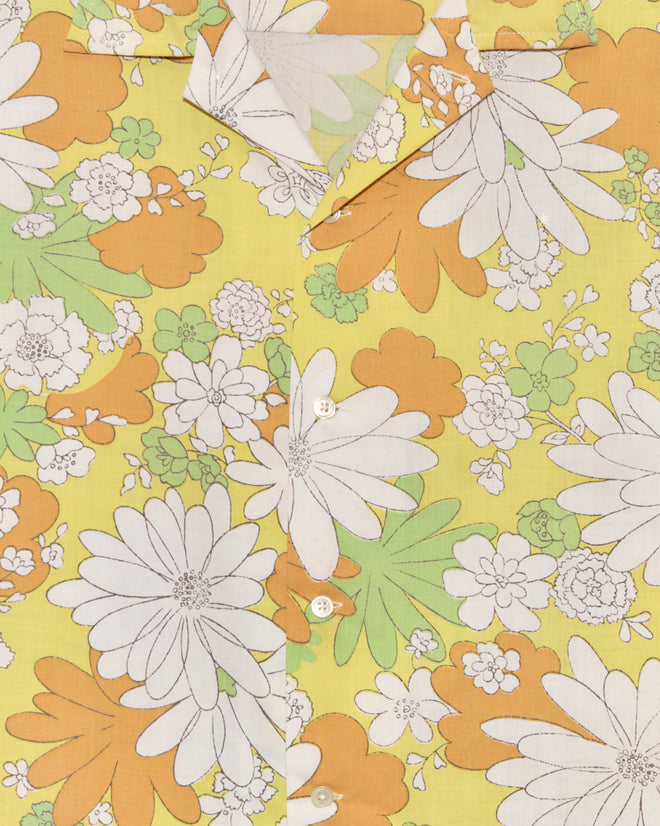 Storytime Floral Shirt - XL/XXL: Vintage yellow bedsheet shirt featuring white buttons and a bold white, orange, and green floral pattern on a yellow background—a unique statement piece.