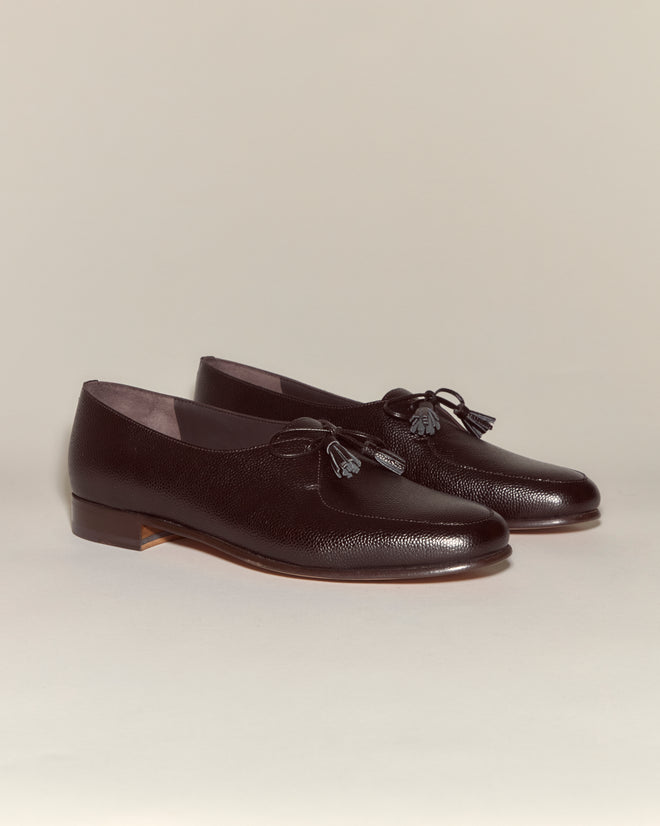 The Tassel Shoes - Brown are vintage loafers crafted from dark brown pebbled leather with tassel accents, shown on a neutral background.