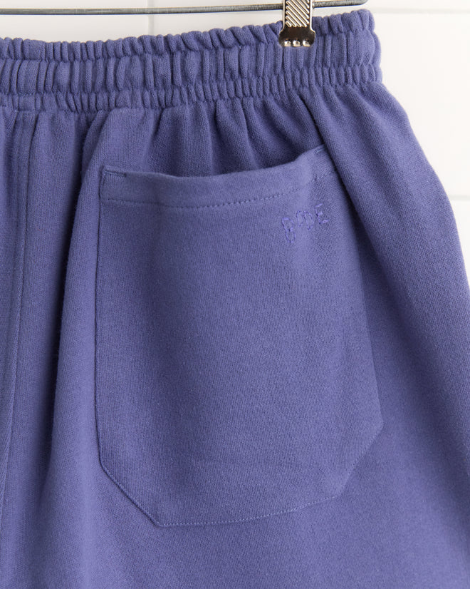 Close-up of the Tennis Player Shorts' blue pocket, featuring a gathered elastic waistband and metal clip, inspired by classic Canadian rugby shorts, shown on a white background.