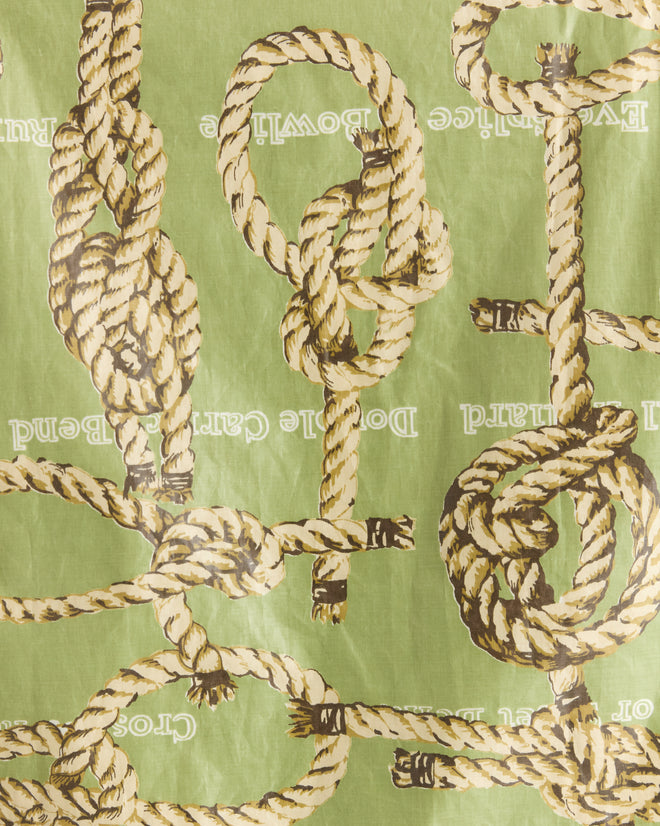 Illustrated sailor's knots on a green background with text instructions, featured on the Topsail Rope Jacket.