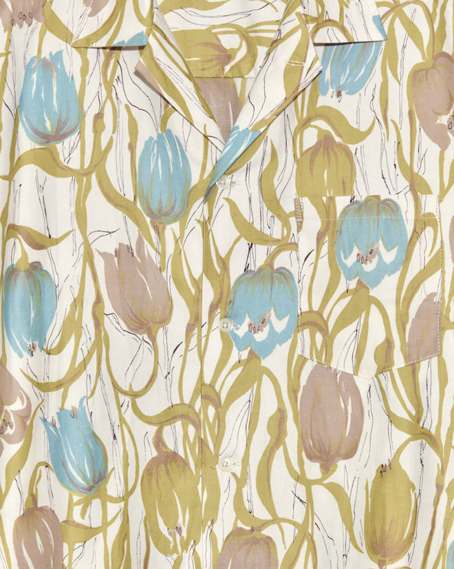 The Tulip Watercolor Shirt - M/L showcases blue and brown tulips with green vines on a white background, creating a unique look.
