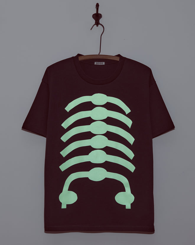 The Skeleton Tee features a glow-in-the-dark ribcage graphic on the front, making it perfect for Halloween styles.
