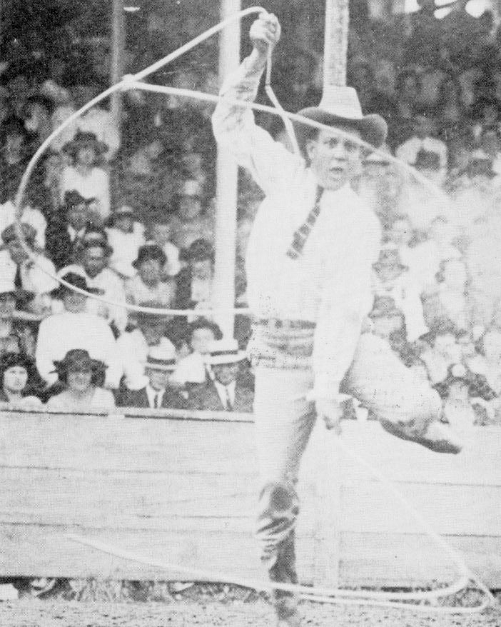 Historic photo of a lassoing performer at a rodeo.