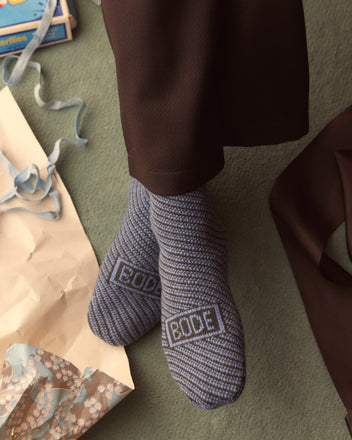 A person wearing Duotone Jacquard Socks - Blue Grey, featuring 