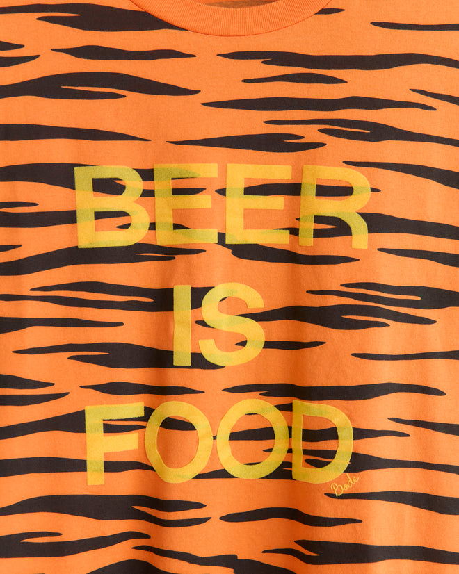 The Tiger Stripe Tee is an orange and black tiger-striped shirt inspired by college mascots, with yellow "BEER IS FOOD" text.