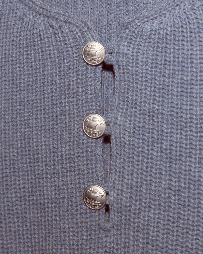 Close-up of the Boat Deck Pullover, a gray virgin wool knit sweater featuring three silver pirate ship buttons arranged vertically.