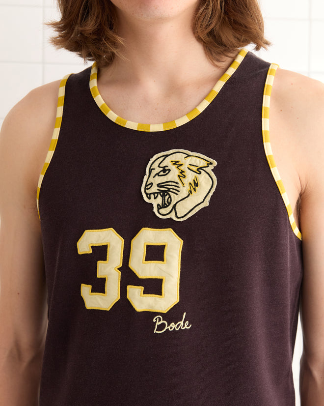 A person is wearing a Bobcat Singlet, a vintage basketball jersey with a panther logo, number 39, and checkered trim.