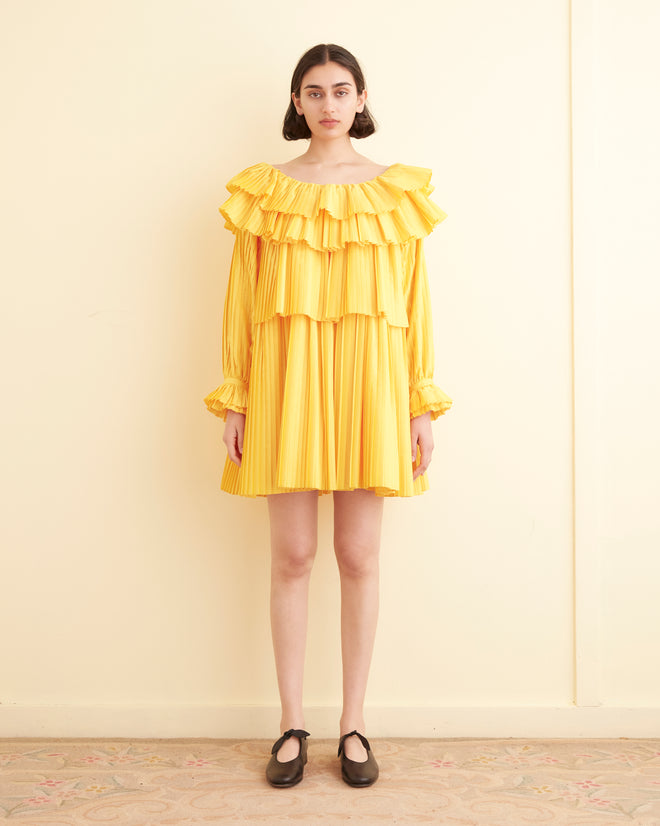 Close-up of the Brunch Dress - Yellow, showcasing cascading tiers and pleated layers, crafted from recycled polyester.