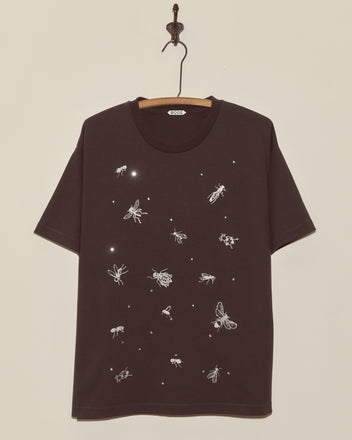 The Bug Tee is a black shirt with white outlined insect illustrations and tiny dots scattered on the front—perfect for fans of quirky Halloween tees.
