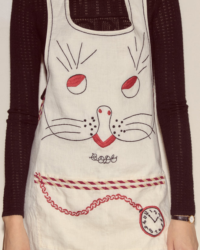 Person wearing a Bunny Apron featuring a bunny face and clock design over a black long-sleeve shirt.