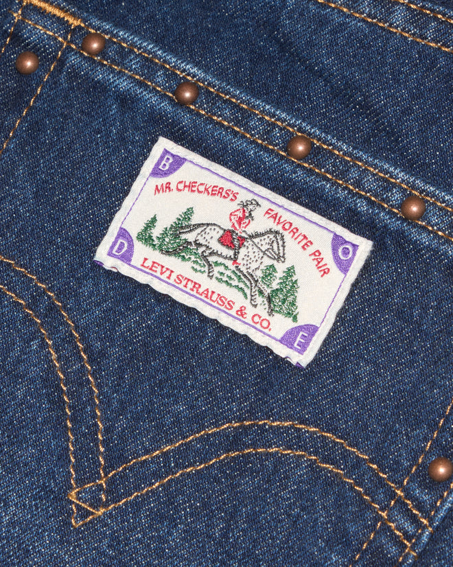 Dark-wash jeans with copper studs.