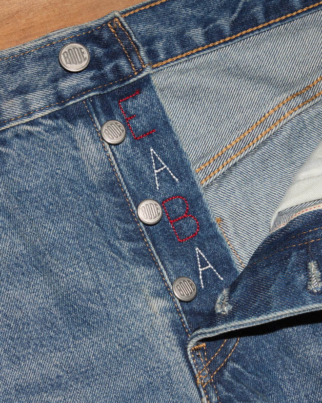 Light-wash jeans with embroidery.