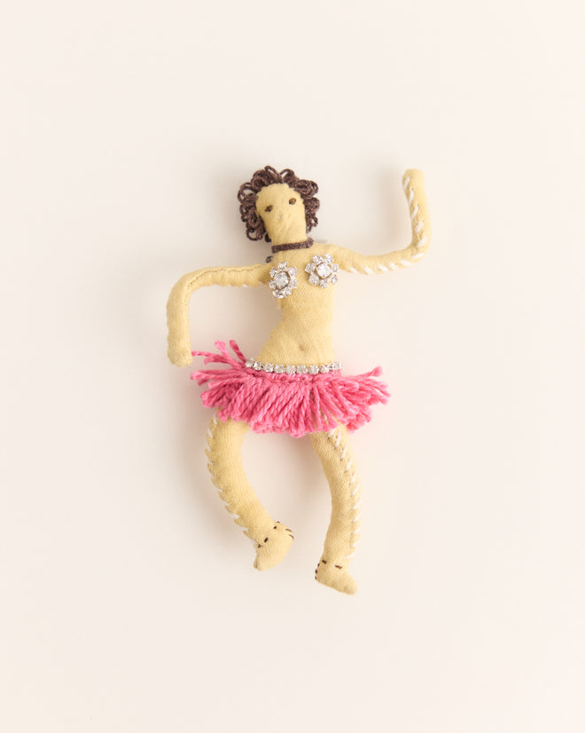 The Calder Fanni Brooch is a handmade fabric doll with curly hair, dressed in a pink skirt and jeweled top inspired by Alexander Calder jewelry, posed with one arm raised.