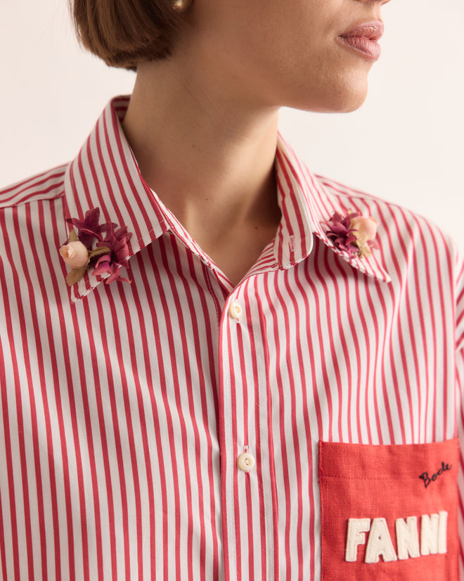Woman wearing the Calder Painted Cirque Long Sleeve Shirt featuring red and white stripes, a floral collar, a red FANNI pocket patch, and handmade New York craftsmanship.
