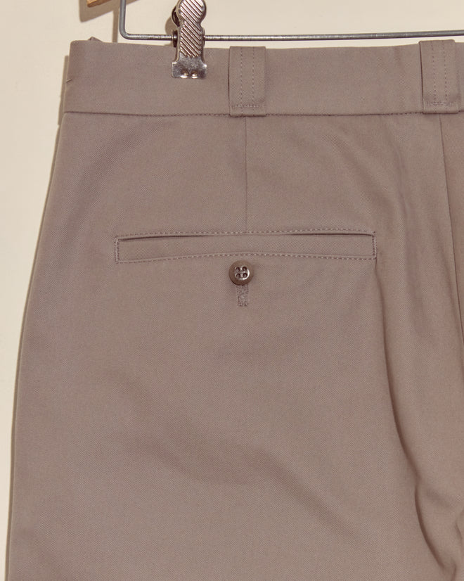 Close-up of the Campus Trousers - Grey, crafted from heavyweight cotton twill, featuring a back pocket with button and belt loops—a tribute to classic collegiate style.
