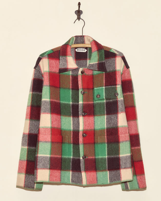Cedarwood Jacket - XS: A unique midcentury wool jacket in red, green, cream, and brown plaid tones, made in New York and displayed on a wall hook.