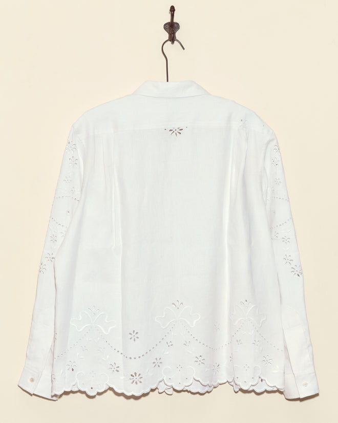 Chamomile Patch Short Sleeve Shirt - M with delicate eyelet embroidery, photographed from the back while hanging on a hook—a unique and stylish piece.