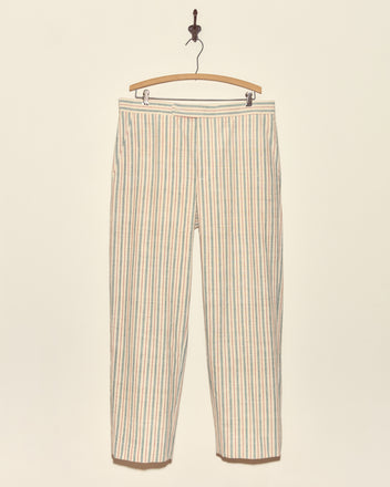 Chart Stripe Trousers - 36: Beige handwoven trousers with vertical pastel blue, pink, and green stripes, crafted from vintage Chinese fabric, displayed on a wooden hanger against a wall.