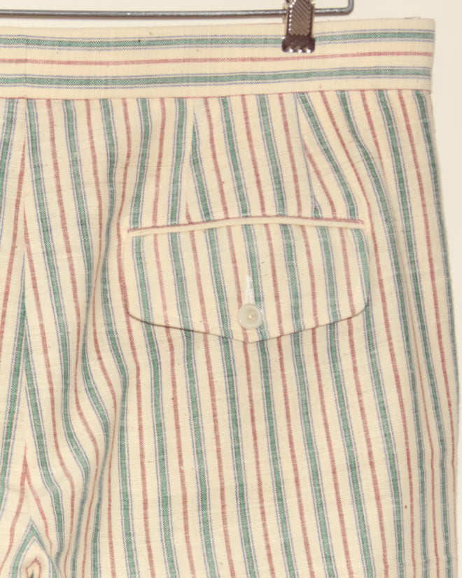 Close-up of Chart Stripe Trousers - 36, handwoven from vintage Chinese fabric with unique stripes and a buttoned back pocket, displayed on a metal hanger.