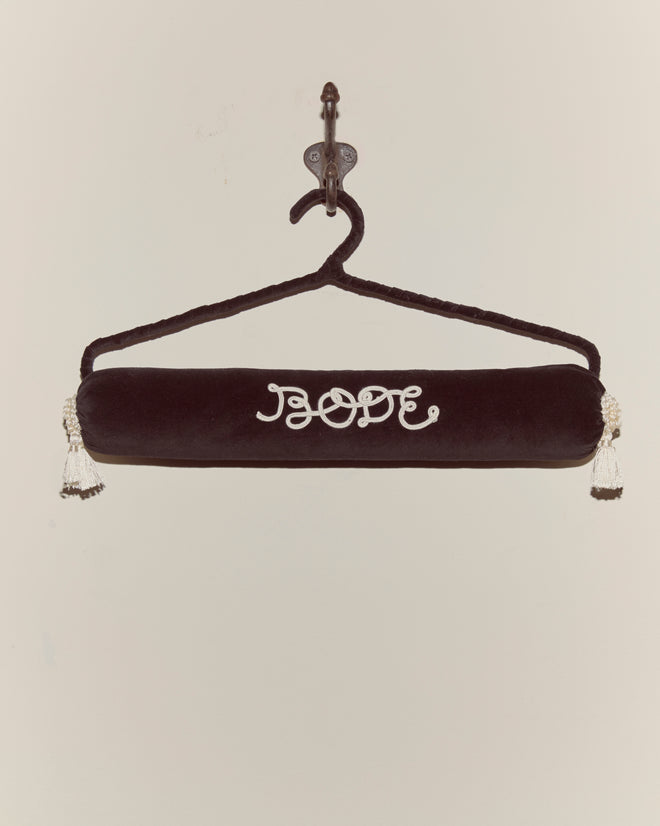 The Cloakroom Hanger - Black features “BOOF” embroidered in white on plush black velvet with a velvet ribbon, elegantly displayed on a wall hook.