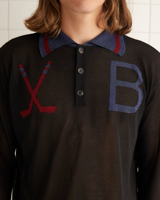 Black lyocell yarn long sleeve polo sweater featuring red and blue knitted designs on chest. This sweater features multi-stripe bottom band and sleeves.